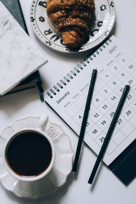 cup of black coffee beside a calendar